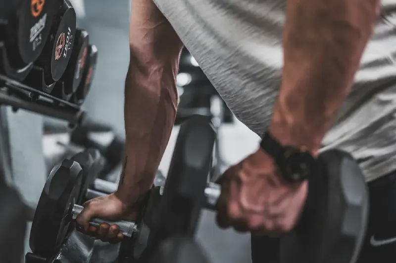 Adjustable and fixed dumbbells arranged for a compact home gym