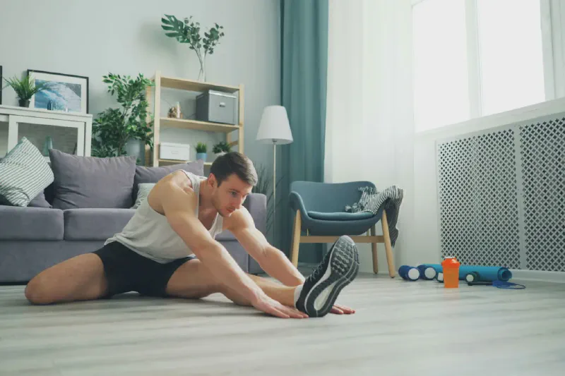Compact dumbbells arranged on a workout mat in a small apartment living space